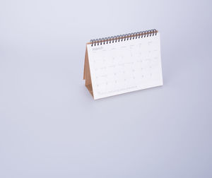 High angle view of desk calendar on white background