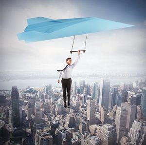 Full length of man standing by buildings in city against sky