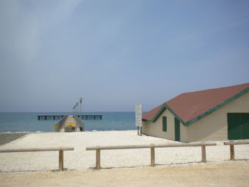 View of built structure by sea