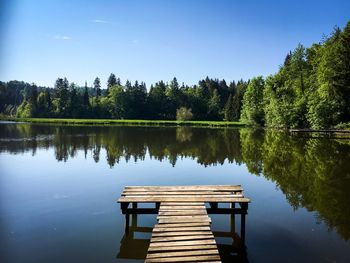 Pier on lake against sky