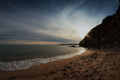 Scenic view of beach against sky during sunset