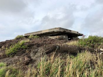 Low angle view of built structure on land against sky