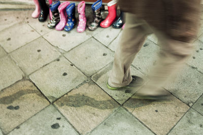 Low section of man standing on tiled floor