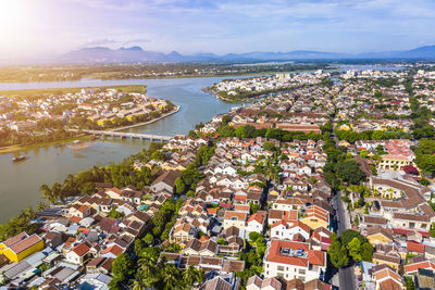 High angle view of townscape by river against sky