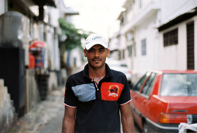 Portrait of man standing in city