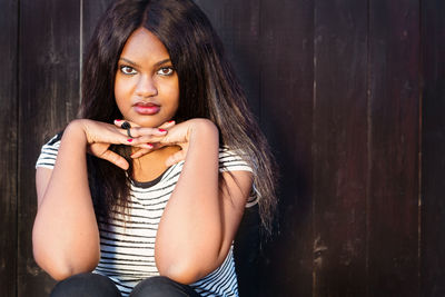 Portrait of young woman sitting outdoors