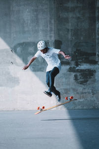 Carefree man skateboarding on road