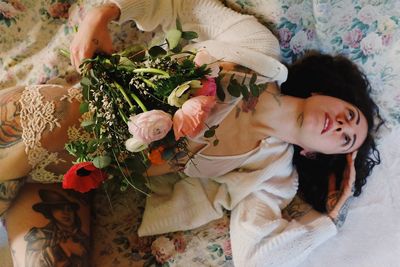 High angle view of woman sleeping on bed