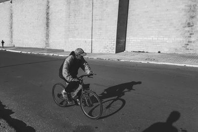 Man riding bicycle on street in city