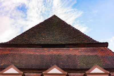 Low angle view of building against cloudy sky