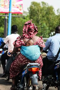 Rear view of people sitting outdoors
