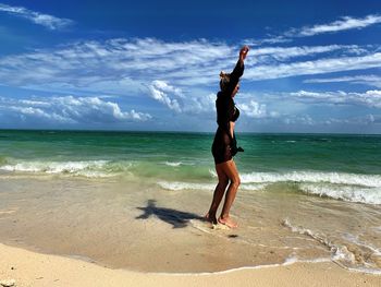 Full length of woman standing at beach