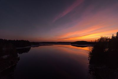 Scenic view of lake against romantic sky at sunset