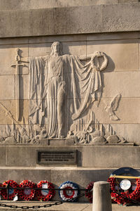 Sculpture of statues on wall of building