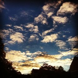 Low angle view of building against cloudy sky