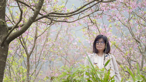 Portrait of young woman against blue sky