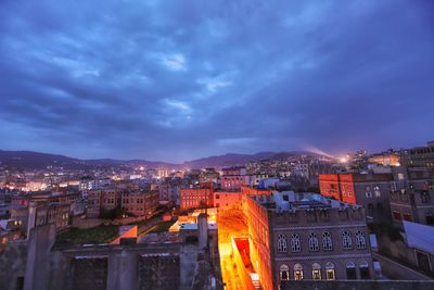 High angle view of illuminated buildings against sky at dusk