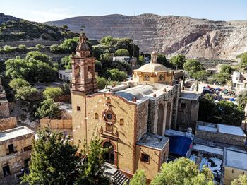 Panoramic view of historic building and mountains against sky