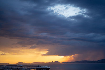 Scenic view of dramatic sky over sea during sunset