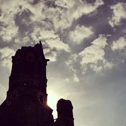 Low angle view of building against cloudy sky