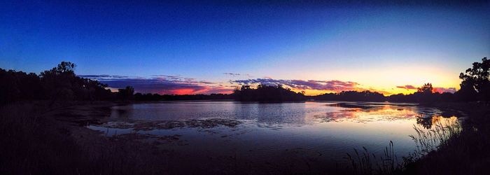 Scenic view of calm lake at sunset