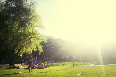 People walking on grassy field in park