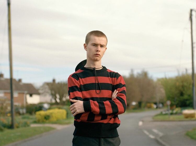 PORTRAIT OF YOUNG MAN STANDING AGAINST THE SKY