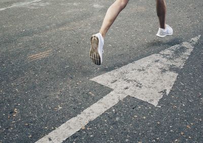 Low section of man walking on street