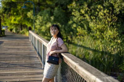 Woman standing on footbridge