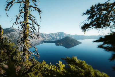 Scenic view of lake and mountains against clear sky