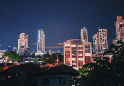 Buildings against blue sky at night