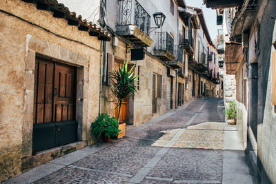 Narrow street amidst buildings in city