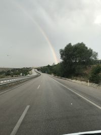 View of rainbow over road against sky