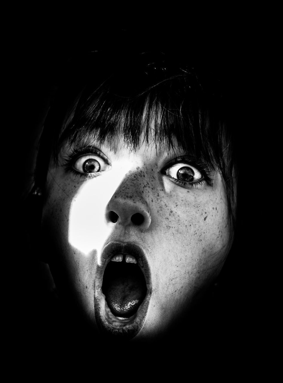 CLOSE-UP PORTRAIT OF BABY GIRL WITH BLACK BACKGROUND