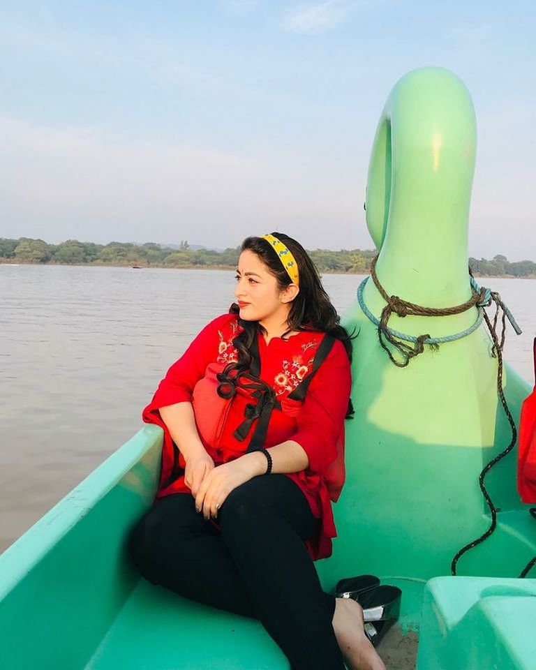 YOUNG WOMAN SITTING IN WATER