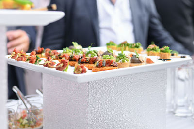 Small canapes appetizers at the wedding the catering