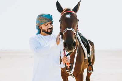 Young man riding horse