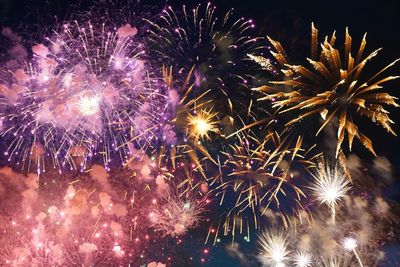 Low angle view of firework display at night