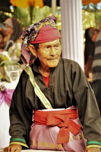 Senior man wearing traditional clothing looking away outdoors