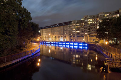 Illuminated city against sky at night