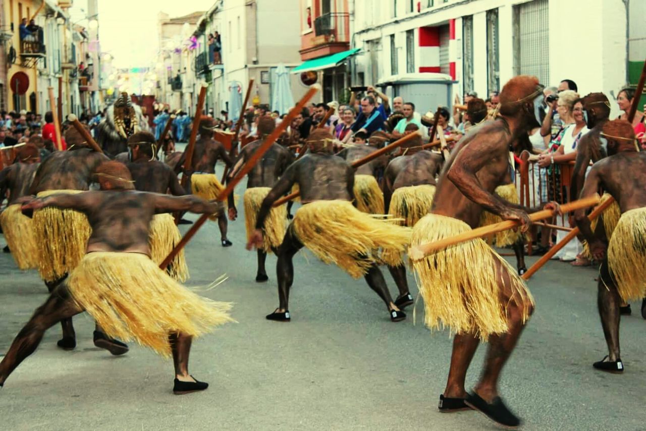 large group of people, animal themes, livestock, men, street, domestic animals, person, medium group of animals, working animal, horse, bird, lifestyles, day, walking, mixed age range, outdoors, crowd, togetherness