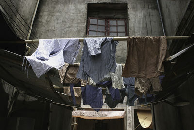 Low angle view of clothes drying against the window