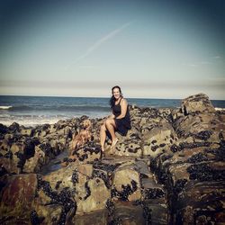 Portrait of woman on beach against sky