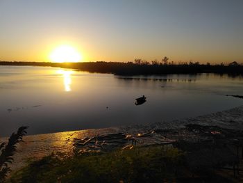 Scenic view of lake against sky during sunset