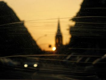 Wet glass window against sky