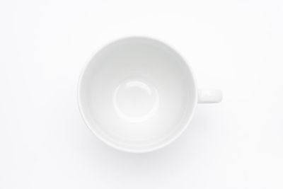 Directly above shot of empty tea cup against white background