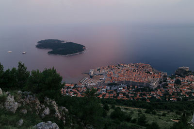 High angle view of sea and mountain against sky