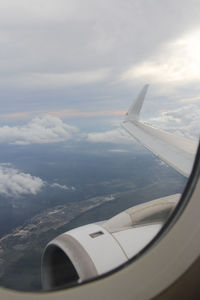 Aerial view of aircraft wing against sky