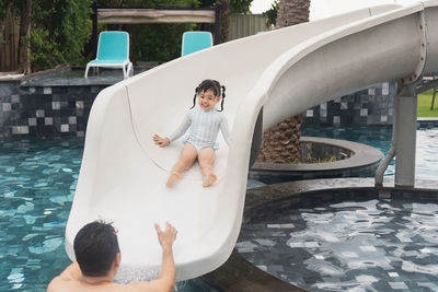 High angle view of woman standing in swimming pool