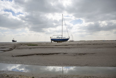 Fisherman boats stuck on the beach in low tide period in leigh-on-sea, uk.